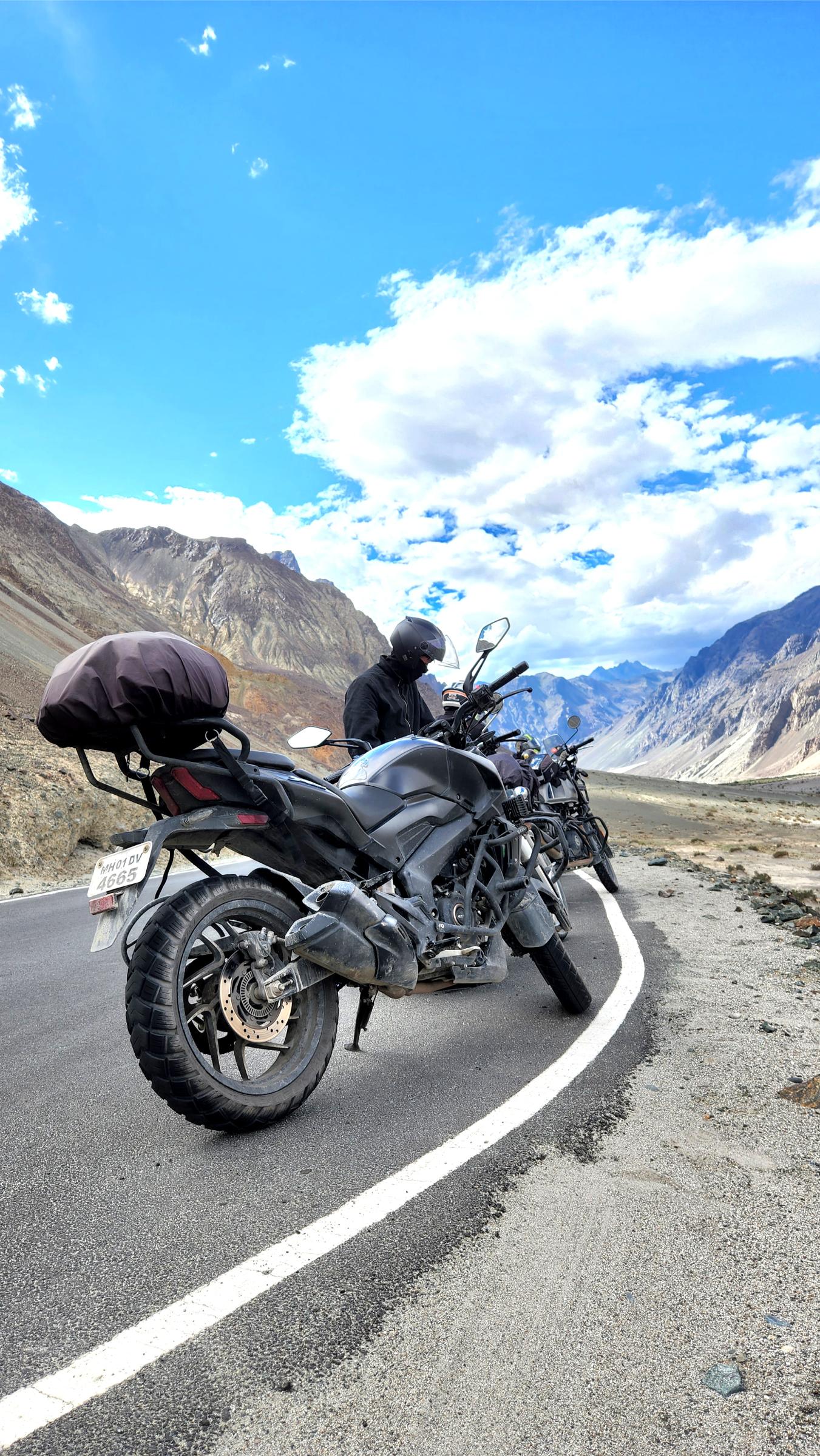 Motorcycle parked on a winding Himalayan road.