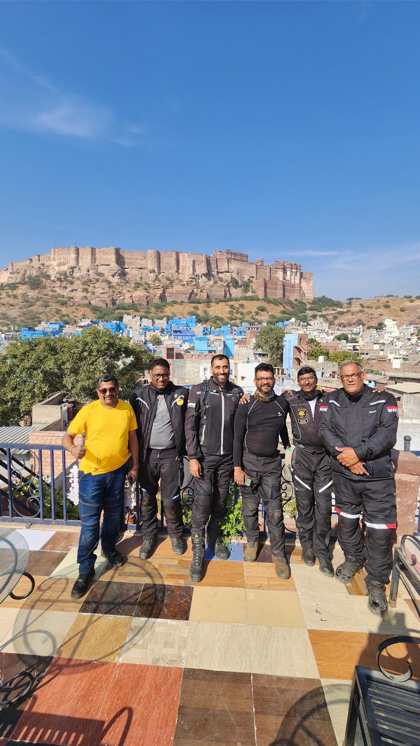 Riders standing together at a fort.